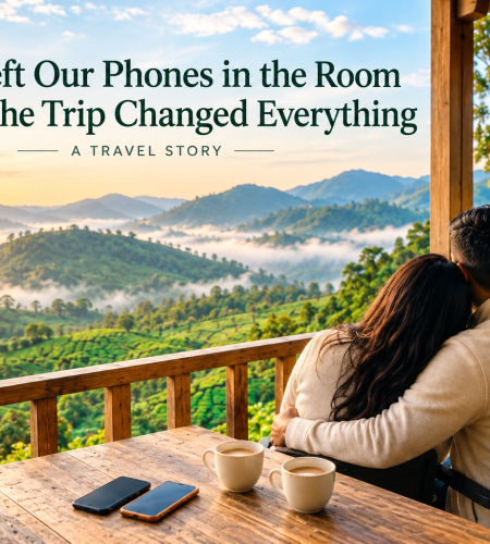Couple sipping tea on a balcony above misty hills at the best resort in Munnar